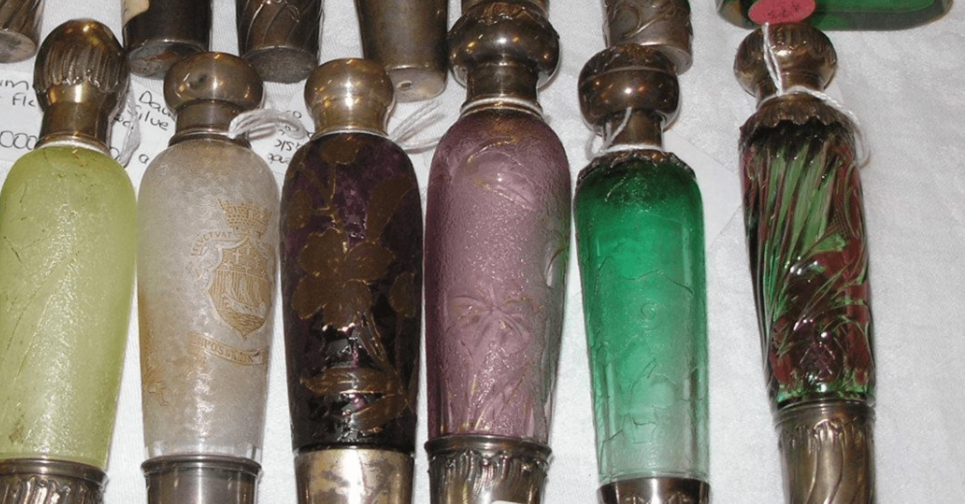 Row of colorful vintage glass perfume stoppers