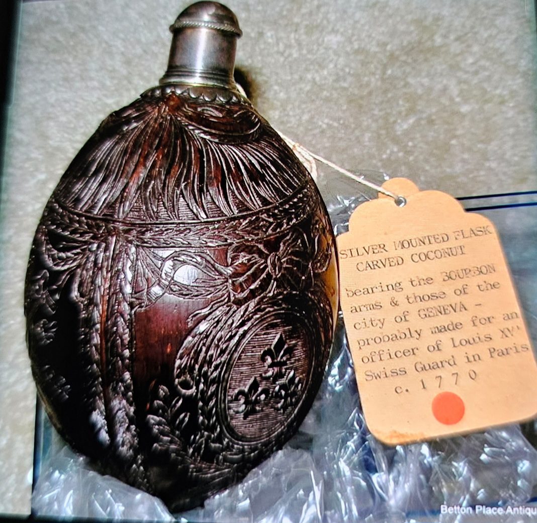 Antique carved coconut flask with silver mount