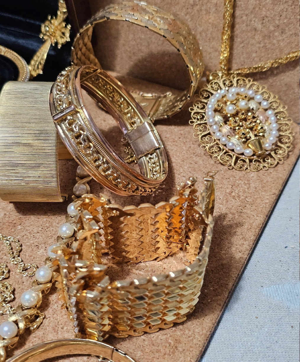 Assorted gold bracelets and pearl pendant